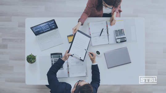 Two business owners reviewing an agreement.