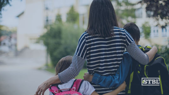Mom walking kids to school.